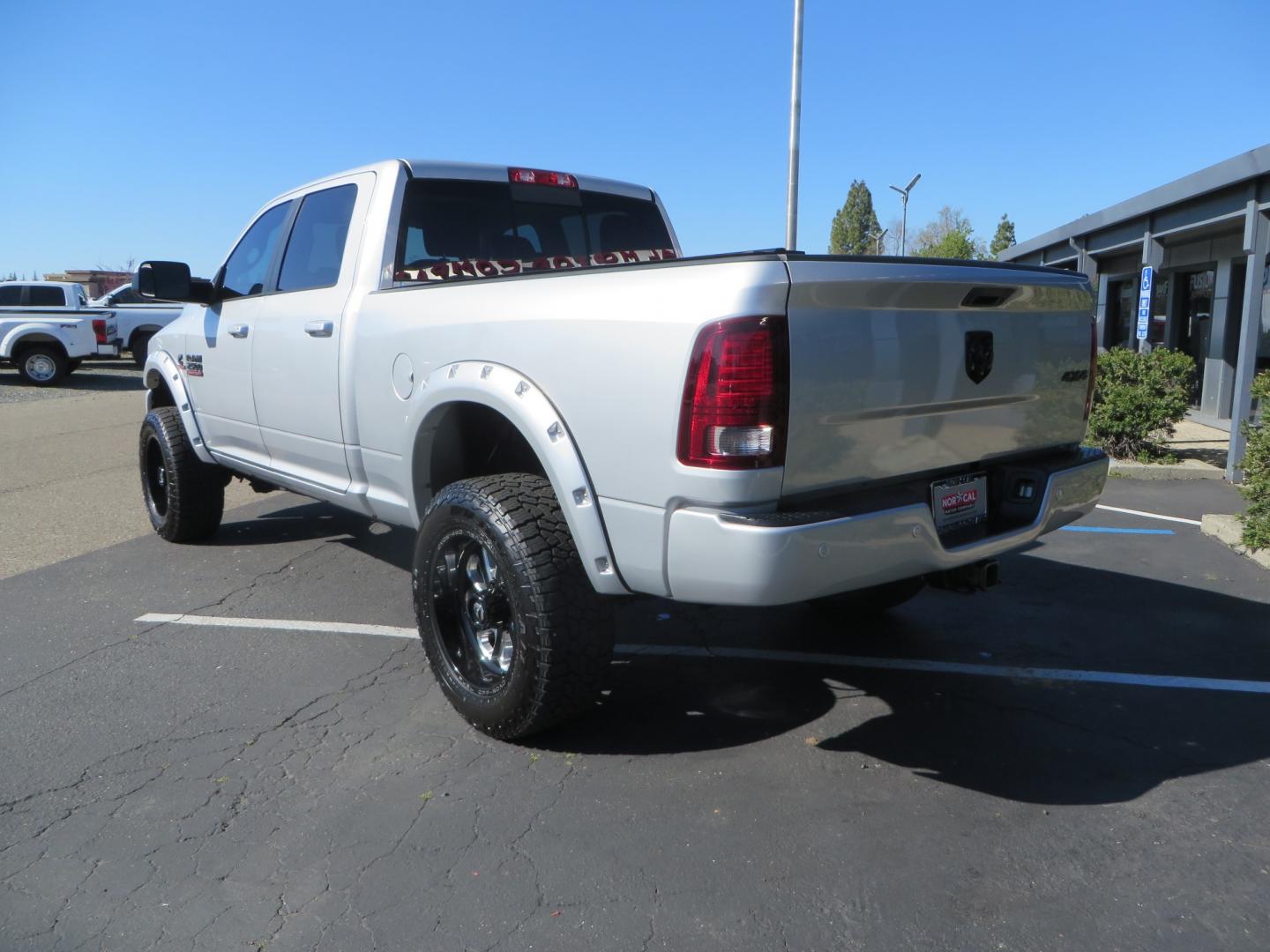 2016 SILVER /BLACK RAM 2500 Laramie Crew Cab SWB 4WD (3C6UR5FL3GG) with an 6.7L L6 OHV 24V TURBO DIESEL engine, 6A transmission, located at 2630 Grass Valley Highway, Auburn, CA, 95603, (530) 508-5100, 38.937893, -121.095482 - Leveled Ram sitting on Fuel Offroad wheels, Falken Wildpeak AT tires, Amp Power steps, Rolling Bed cover, Color matched fender flares, and window tint. - Photo#6